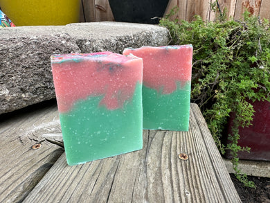 Bar soap with turquoise colored bottom and corral pink on top.