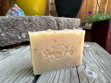 Light beige soap bar with specks of herbs inside