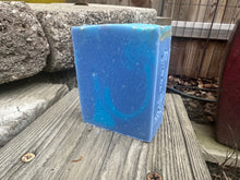 blue soap bars in a backyard with words simon sudz stamped the side