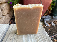 Light brown soap bar with sea moss embedded in it