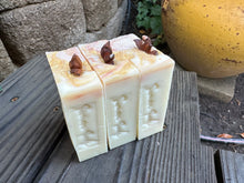 Beige with copper colored swirt soap bar with a piece of anise on top