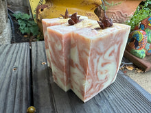 Beige with copper colored swirt soap bar with a piece of anise on top