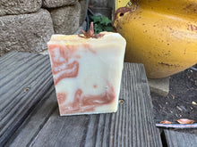 Beige with copper colored swirt soap bar with a piece of anise on top