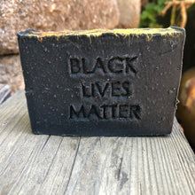 a black bar of handcrafted soap with the words Black Lives Matter stamped on the front