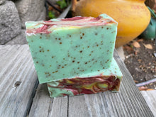 Green soap bar embedded with dried mint leaves