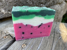 Watermelon soap bar, pink/red layer on the bottom with black specks; white middle layer and light and dark green top layer with glitter sprinkled on top