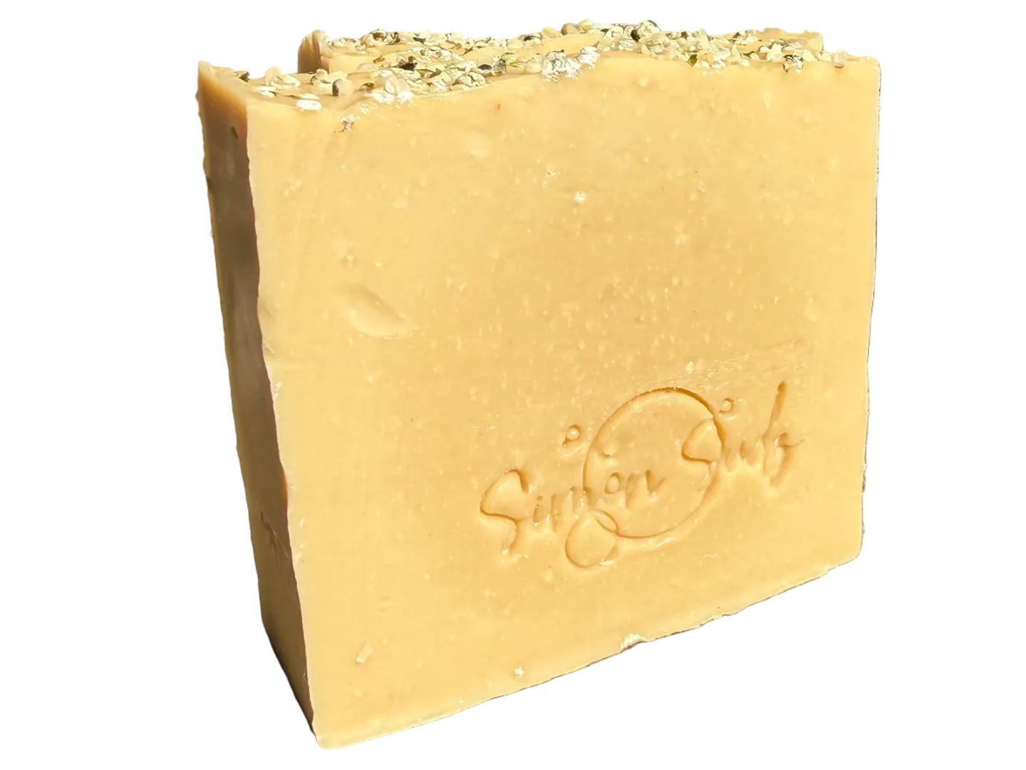 Golden soap bar with hemp seeds on top 