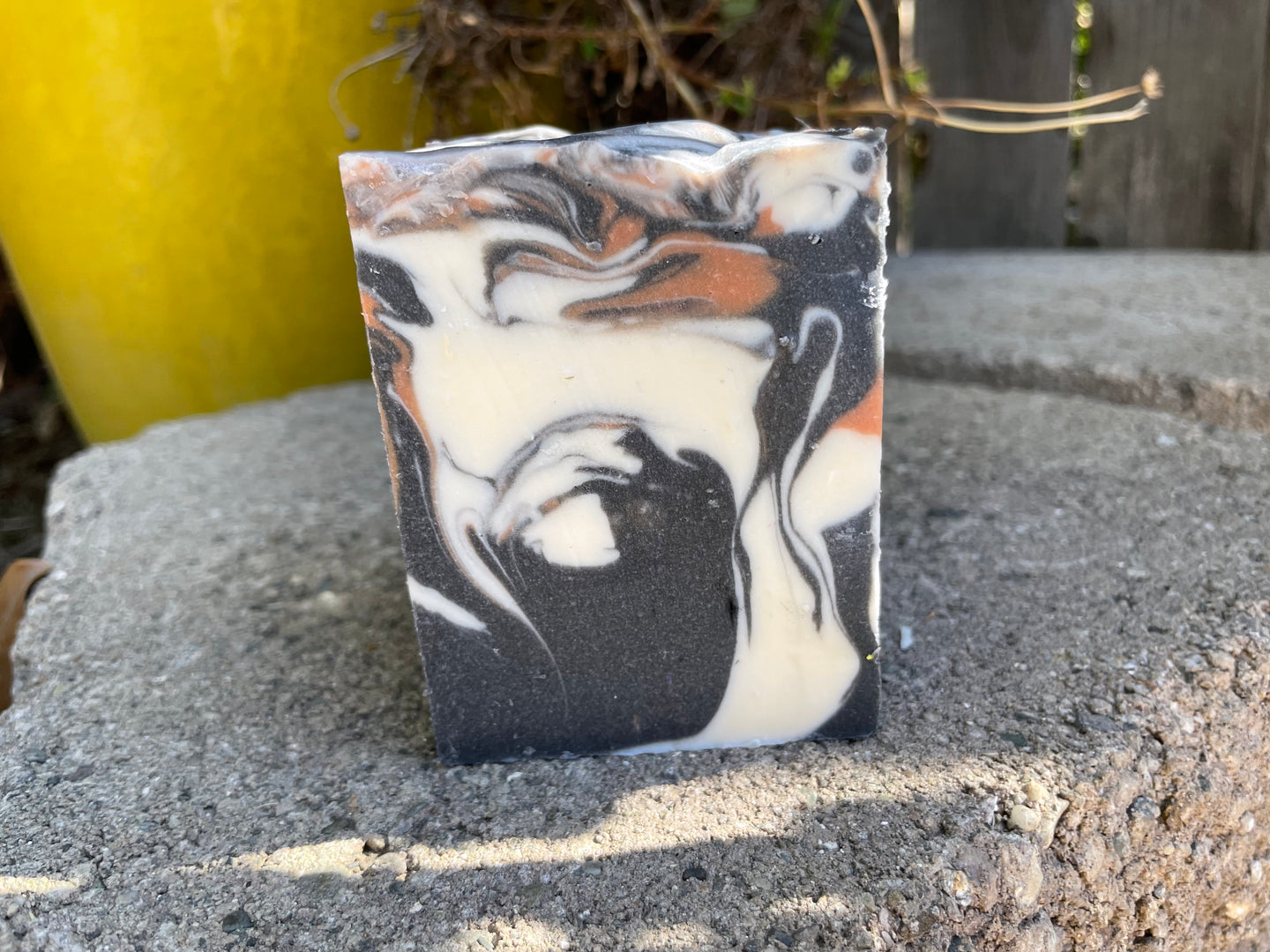 a handmade soap bar with black white and brown colors