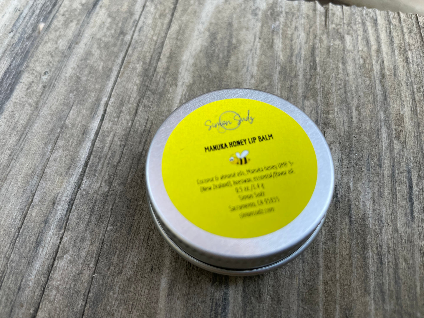 a small tin can with natural lip balm