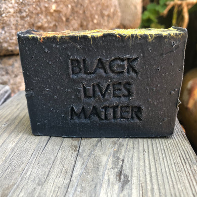 a black bar of handcrafted soap with the words black lives matter