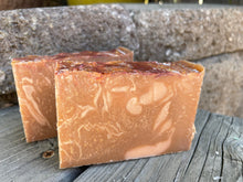 two tan colored soap bars on top of wood plank